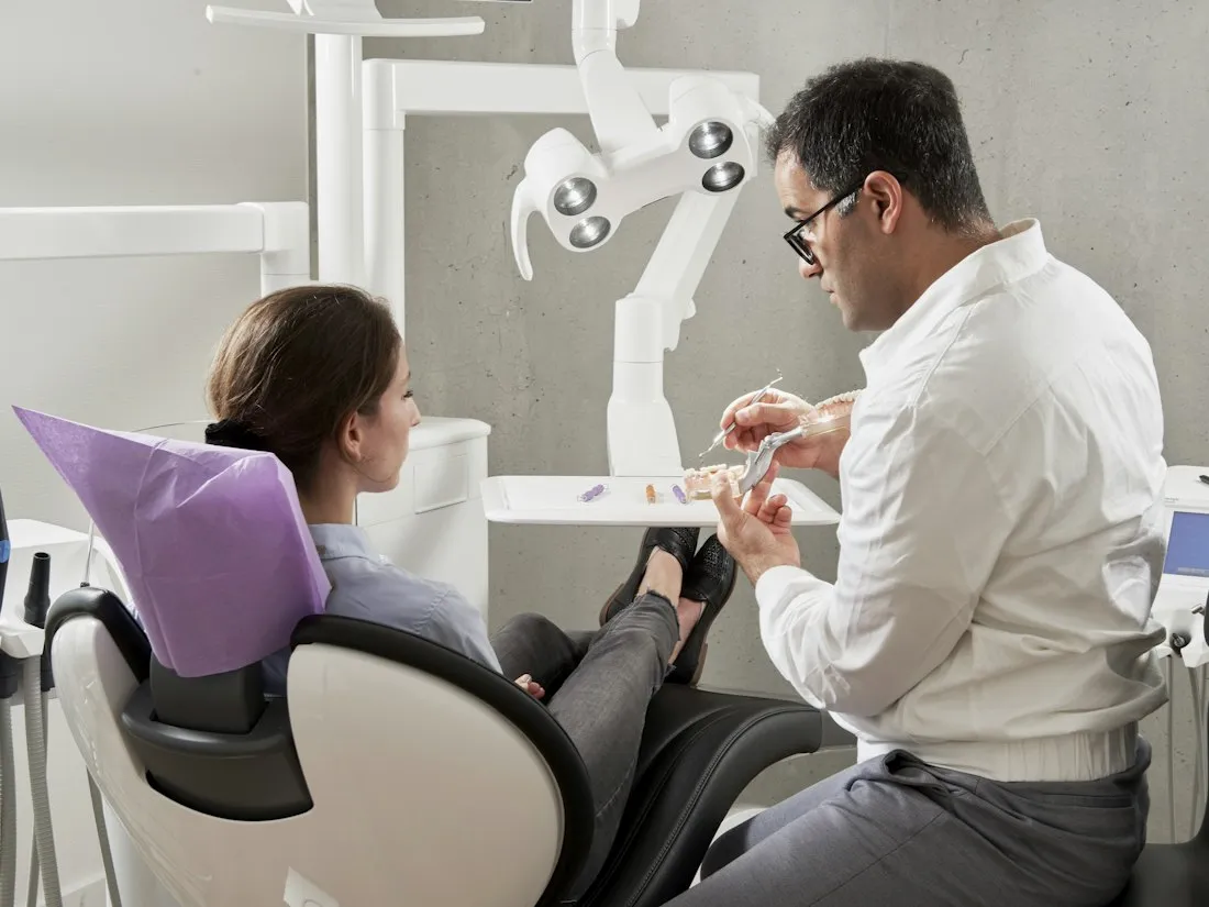 A dentist with a patient in the chair